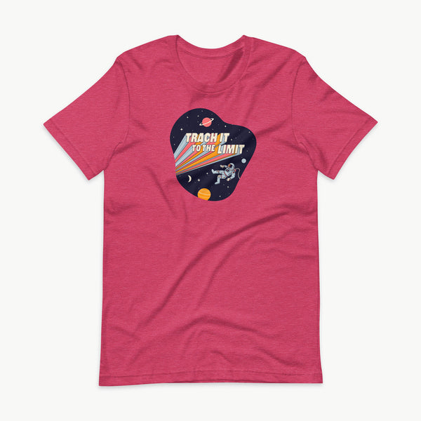 An illustration of an astronaut with a trach and tubing floating in outer space surrounded by stars and planets. Behind the astronaut, bold retro text reads “Trach It to the Limit,” with colorful light trails shooting from the words like a rocket launch. The design appears on a dark background. It is on a heather raspberry adult t-shirt.