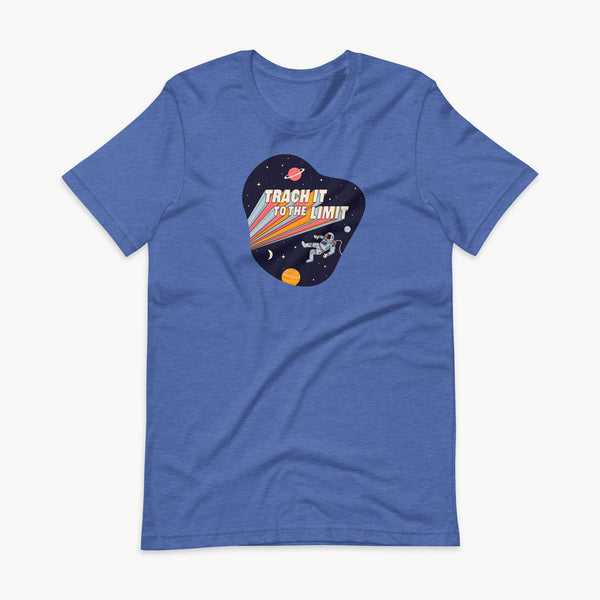 An illustration of an astronaut with a trach and tubing floating in outer space surrounded by stars and planets. Behind the astronaut, bold retro text reads “Trach It to the Limit,” with colorful light trails shooting from the words like a rocket launch. The design appears on a dark background. It is on a heather true royal blue adult t-shirt.